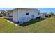 Mobile home with carport and grassy yard at 199 Palm Air Dr, Osprey, FL 34229