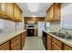 Galley style kitchen with wood cabinets and stainless steel appliances at 199 Palm Air Dr, Osprey, FL 34229