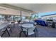 Covered patio with tables, chairs, and grill at 199 Palm Air Dr, Osprey, FL 34229
