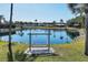 Serene pond with a relaxing swing bench at 199 Palm Air Dr, Osprey, FL 34229