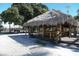 Outdoor Tiki Bar with thatched roof and seating at 199 Palm Air Dr, Osprey, FL 34229