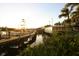 Picturesque waterfront restaurant with boats docked alongside, idyllic sunset view at 199 Palm Air Dr, Osprey, FL 34229