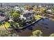 Aerial view of the waterfront property with lush landscaping and serene pond at 20 Saint Croix Way, Englewood, FL 34223