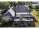 Aerial view of the home showcasing the screened-in pool and lush landscaping at 20 Saint Croix Way, Englewood, FL 34223