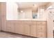 Double vanity bathroom with beige cabinets at 20 Saint Croix Way, Englewood, FL 34223