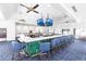 Modern clubhouse bar with green tile and blue barstools at 20 Saint Croix Way, Englewood, FL 34223