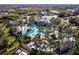Aerial view showcasing a luxurious community pool surrounded by palm trees and inviting lounge areas at 20 Saint Croix Way, Englewood, FL 34223