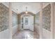 Elegant entryway with tiled floors and decorative wallpaper at 20 Saint Croix Way, Englewood, FL 34223