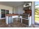 Stainless steel appliances and a built-in grill highlight this outdoor kitchen at 20 Saint Croix Way, Englewood, FL 34223