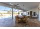 Relaxing wicker furniture surrounds a table on the patio overlooking the pool at 20 Saint Croix Way, Englewood, FL 34223