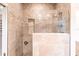 Walk-in shower with glass enclosure and pebble accents at 20 Saint Croix Way, Englewood, FL 34223