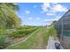 Landscaped backyard with walkway to canal at 201 Villa Dr # 201, Osprey, FL 34229