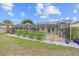 Screened pool and patio area with lush landscaping at 201 Villa Dr # 201, Osprey, FL 34229