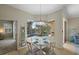 Bright breakfast nook with table and chairs overlooking the pool and screened lanai at 205 Tortuga Dr, Nokomis, FL 34275