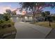 Two-car garage and landscaped yard at dusk at 205 Tortuga Dr, Nokomis, FL 34275