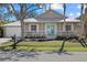 One-story tan house with teal front door and metal roof at 205 Tortuga Dr, Nokomis, FL 34275