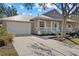 Charming single-story home with metal roof and teal door at 205 Tortuga Dr, Nokomis, FL 34275