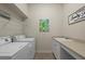 Convenient laundry room with washer, dryer, and countertop at 205 Tortuga Dr, Nokomis, FL 34275