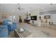 Open living room with fireplace, comfortable seating, and adjacent kitchen at 205 Tortuga Dr, Nokomis, FL 34275
