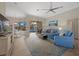 Open living space with blue sofas, a large TV, and access to a screened lanai at 205 Tortuga Dr, Nokomis, FL 34275