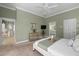 Main bedroom with king bed, en-suite bathroom access, and view of kitchen at 205 Tortuga Dr, Nokomis, FL 34275