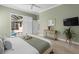 Main bedroom with king bed and sliding doors to the pool area at 205 Tortuga Dr, Nokomis, FL 34275