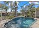 Relaxing screened pool and spa with tranquil water feature at 205 Tortuga Dr, Nokomis, FL 34275