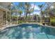 Inviting screened pool with water feature, offering serene canal views at 205 Tortuga Dr, Nokomis, FL 34275