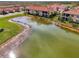 Aerial view of community with lake and villas at 23210 Banbury Way # 101, Venice, FL 34293