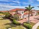 Aerial view of a townhome community with a lake and lush landscaping at 23210 Banbury Way # 101, Venice, FL 34293