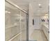 Elegant bathroom with double vanity, large shower, and tile flooring at 23210 Banbury Way # 101, Venice, FL 34293