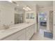 Spa-like bathroom with double sinks, quartz countertop and large mirror at 23210 Banbury Way # 101, Venice, FL 34293