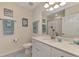 Clean bathroom with white vanity, bathtub, and teal towels at 23210 Banbury Way # 101, Venice, FL 34293