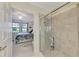 Bathroom with shower and view into bedroom at 23210 Banbury Way # 101, Venice, FL 34293