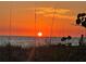 Orange sunset over the ocean and beach at 23210 Banbury Way # 101, Venice, FL 34293