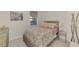 Cozy bedroom with full-size bed and floral bedding at 23210 Banbury Way # 101, Venice, FL 34293