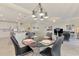 Dining area with a glass table and modern light fixture at 23210 Banbury Way # 101, Venice, FL 34293