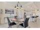 Elegant dining room with round glass table and modern chairs at 23210 Banbury Way # 101, Venice, FL 34293