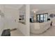 Bright entryway with a bench and view into the living room at 23210 Banbury Way # 101, Venice, FL 34293