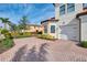 Exterior of townhome with brick driveway and landscaping at 23210 Banbury Way # 101, Venice, FL 34293