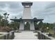 Quaint gazebo with seating area and bridge access at 23210 Banbury Way # 101, Venice, FL 34293