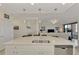 Modern kitchen island with double sink, overlooking living room at 23210 Banbury Way # 101, Venice, FL 34293