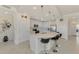 Spacious kitchen with white cabinets, large island, and breakfast bar at 23210 Banbury Way # 101, Venice, FL 34293
