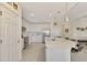 Modern kitchen with white cabinets, stainless steel appliances and island at 23210 Banbury Way # 101, Venice, FL 34293
