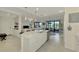 Modern kitchen with white cabinets, island, and stainless steel appliances at 23210 Banbury Way # 101, Venice, FL 34293