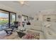 Open living space with sectional sofa, view of kitchen and patio at 23210 Banbury Way # 101, Venice, FL 34293