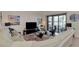 Comfortable living room with sectional sofa, large TV and lake view at 23210 Banbury Way # 101, Venice, FL 34293