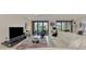 Bright living room with sectional sofa, large TV, and access to a relaxing patio at 23210 Banbury Way # 101, Venice, FL 34293