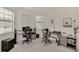 Spacious home office with two desks, chairs, and ample natural light at 23210 Banbury Way # 101, Venice, FL 34293