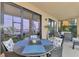 Screened porch with lake view and outdoor furniture at 23210 Banbury Way # 101, Venice, FL 34293